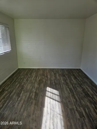 an empty room with wooden floor