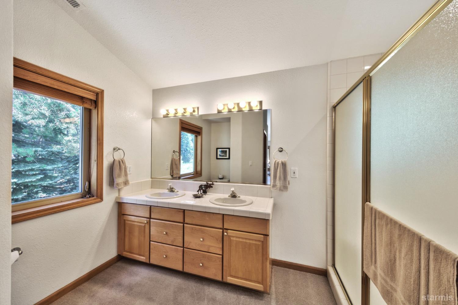 34235 Fremont Road Kirkwood, CA 95646 - Photo 20 of 31 a bathroom with a double vanity sink and a mirror