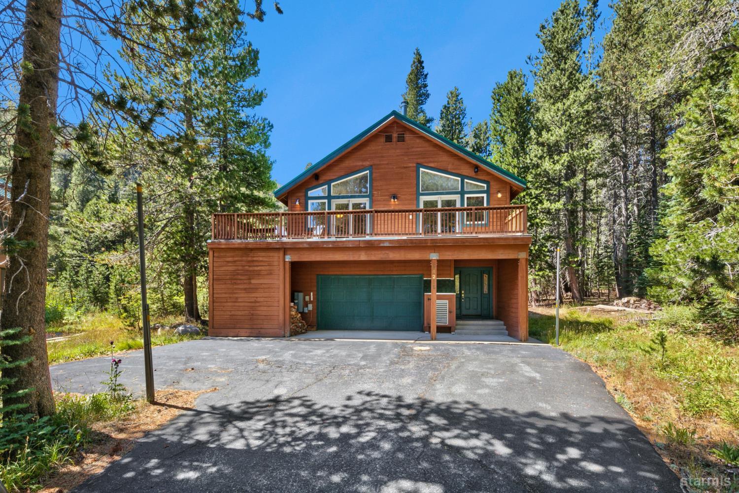 34235 Fremont Road Kirkwood, CA 95646 - Photo 2 of 31 a front view of a house with a yard and garage