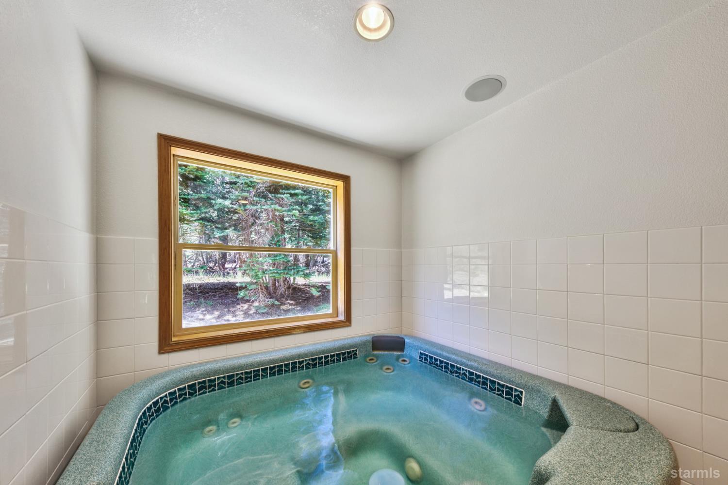 34235 Fremont Road Kirkwood, CA 95646 - Photo 24 of 31 a bathroom with a bathtub and window