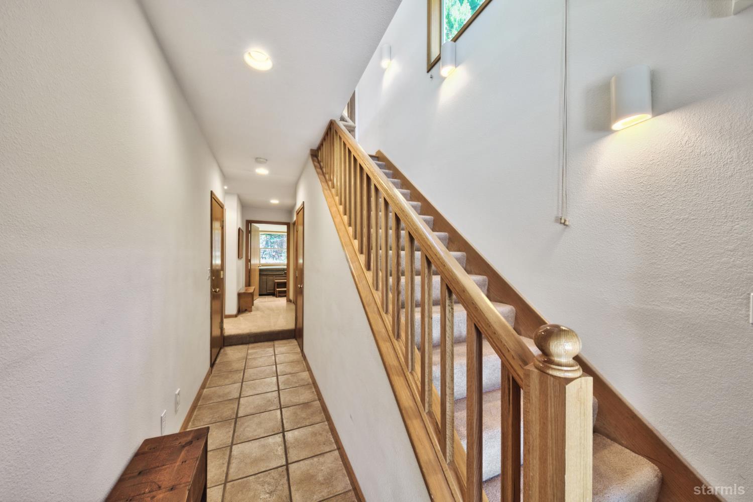 34235 Fremont Road Kirkwood, CA 95646 - Photo 6 of 31 a view of a hallway with wooden floor and staircase