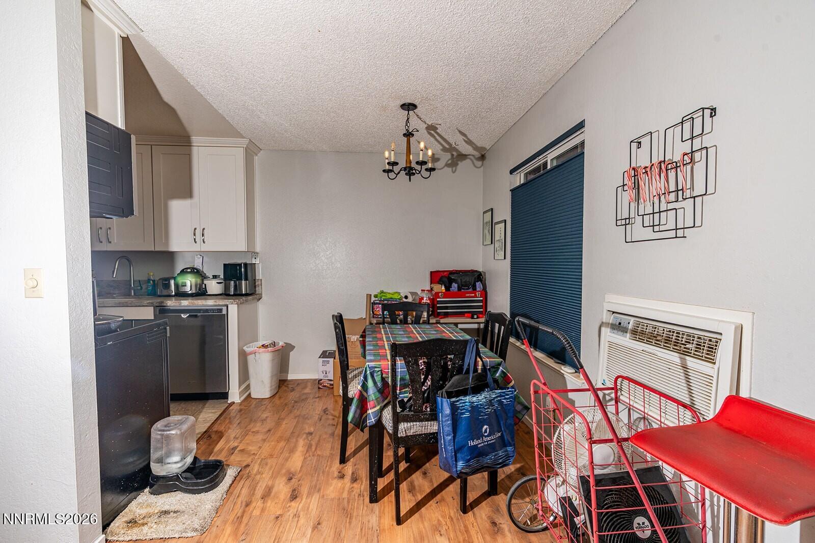 4608 Neil Road, Unit 215 Reno, NV 89502 - Photo 13 of 17 a view of a dining room with furniture and a kitchen