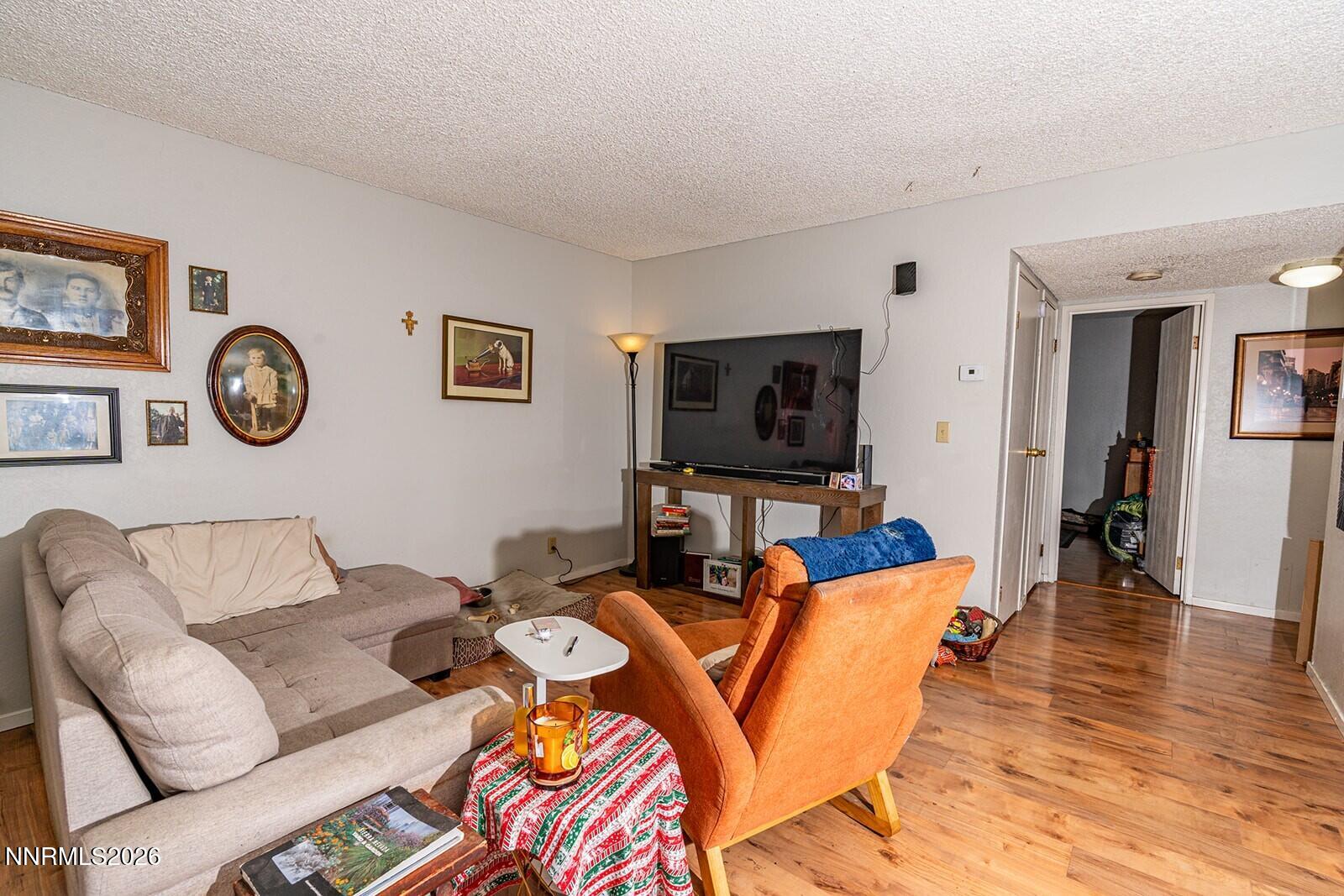 4608 Neil Road, Unit 215 Reno, NV 89502 - Photo 13 of 22 a living room with furniture and a flat screen tv