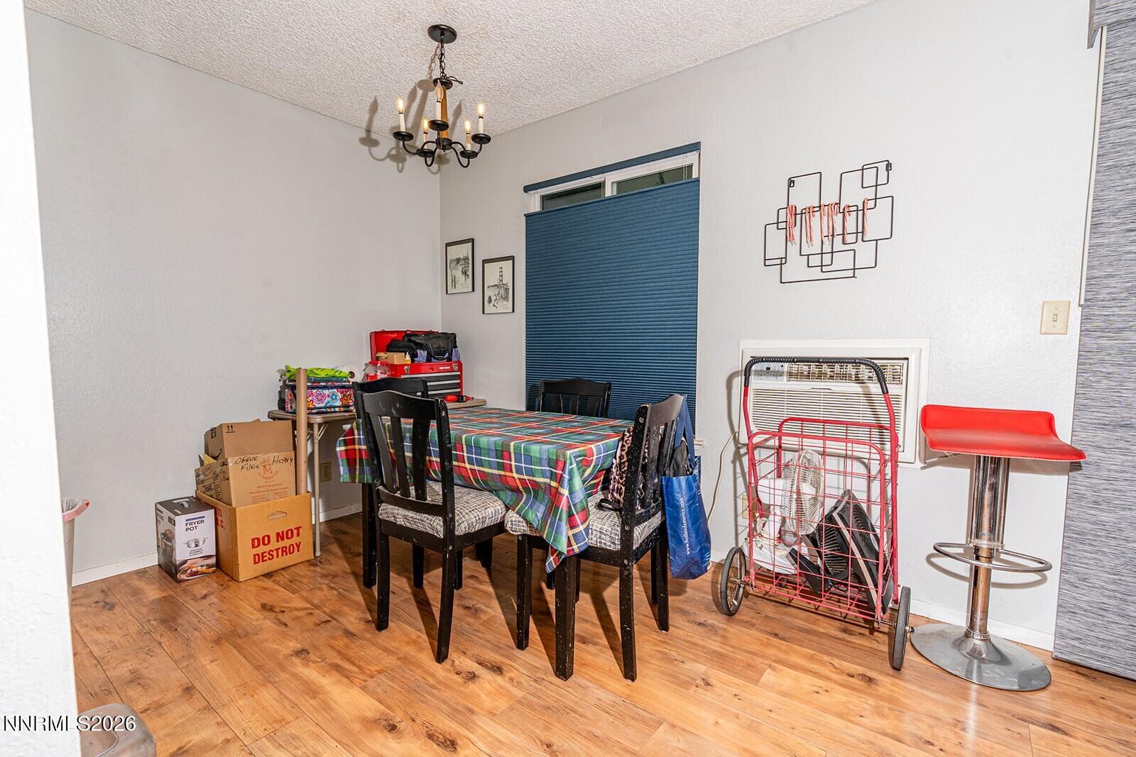 4608 Neil Road, Unit 215 Reno, NV 89502 - Photo 14 of 22 a view of a dining room with furniture and chandelier