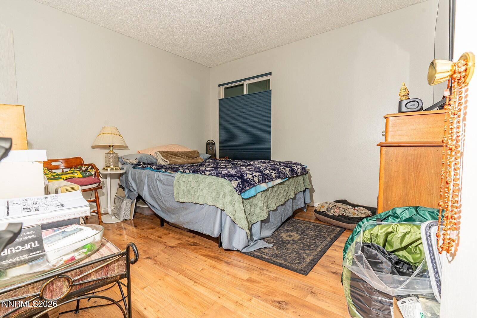 4608 Neil Road, Unit 215 Reno, NV 89502 - Photo 18 of 22 a bedroom with a bed and a table