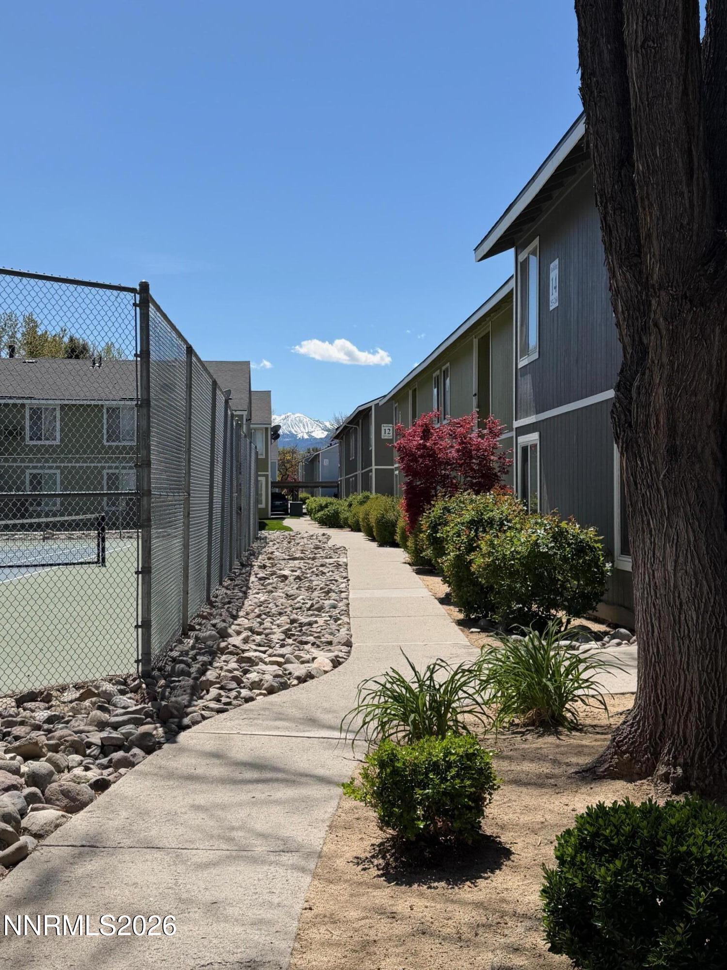 4608 Neil Road, Unit 215 Reno, NV 89502 - Photo 8 of 17 a front view of a house with a yard and garage