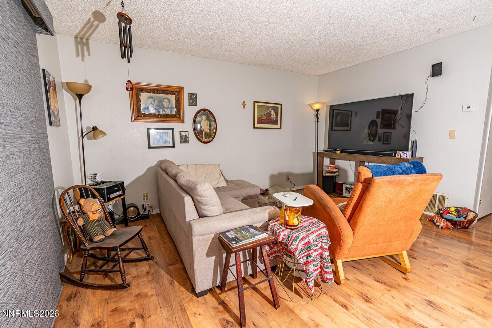 4608 Neil Road, Unit 215 Reno, NV 89502 - Photo 9 of 17 a living room with furniture and a flat screen tv