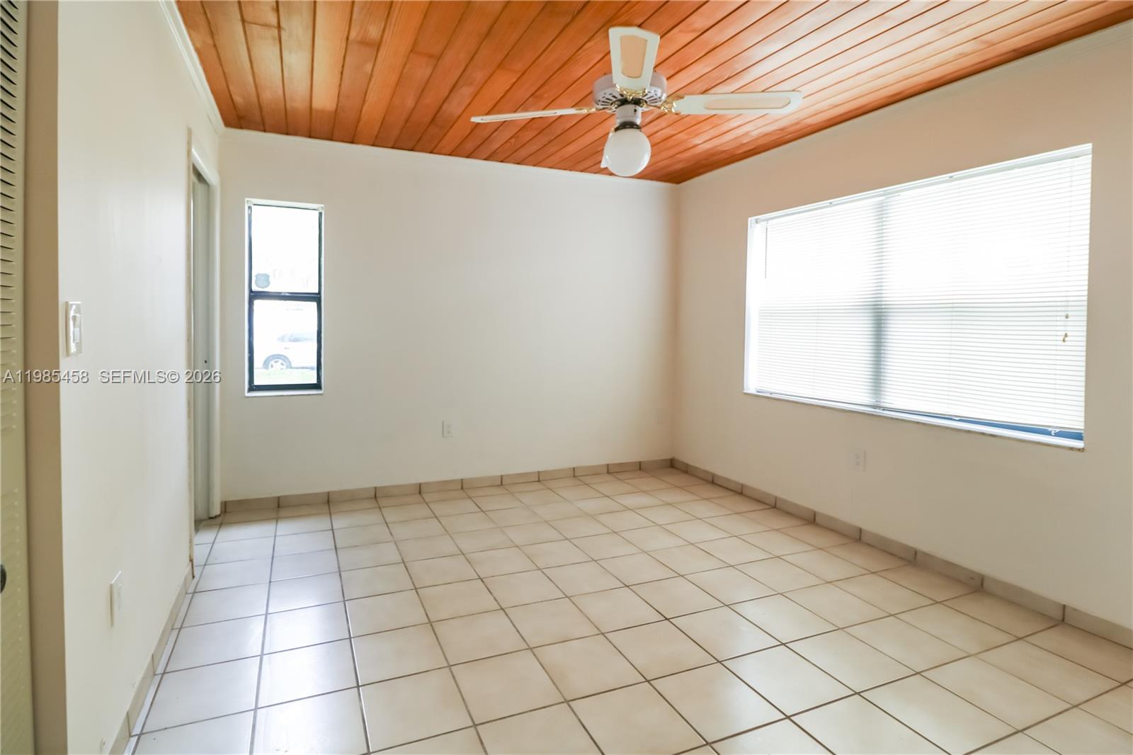 12955 Southwest 66th Lane, Unit 2122 Miami, FL 33183 - Photo 13 of 16 an empty room with windows