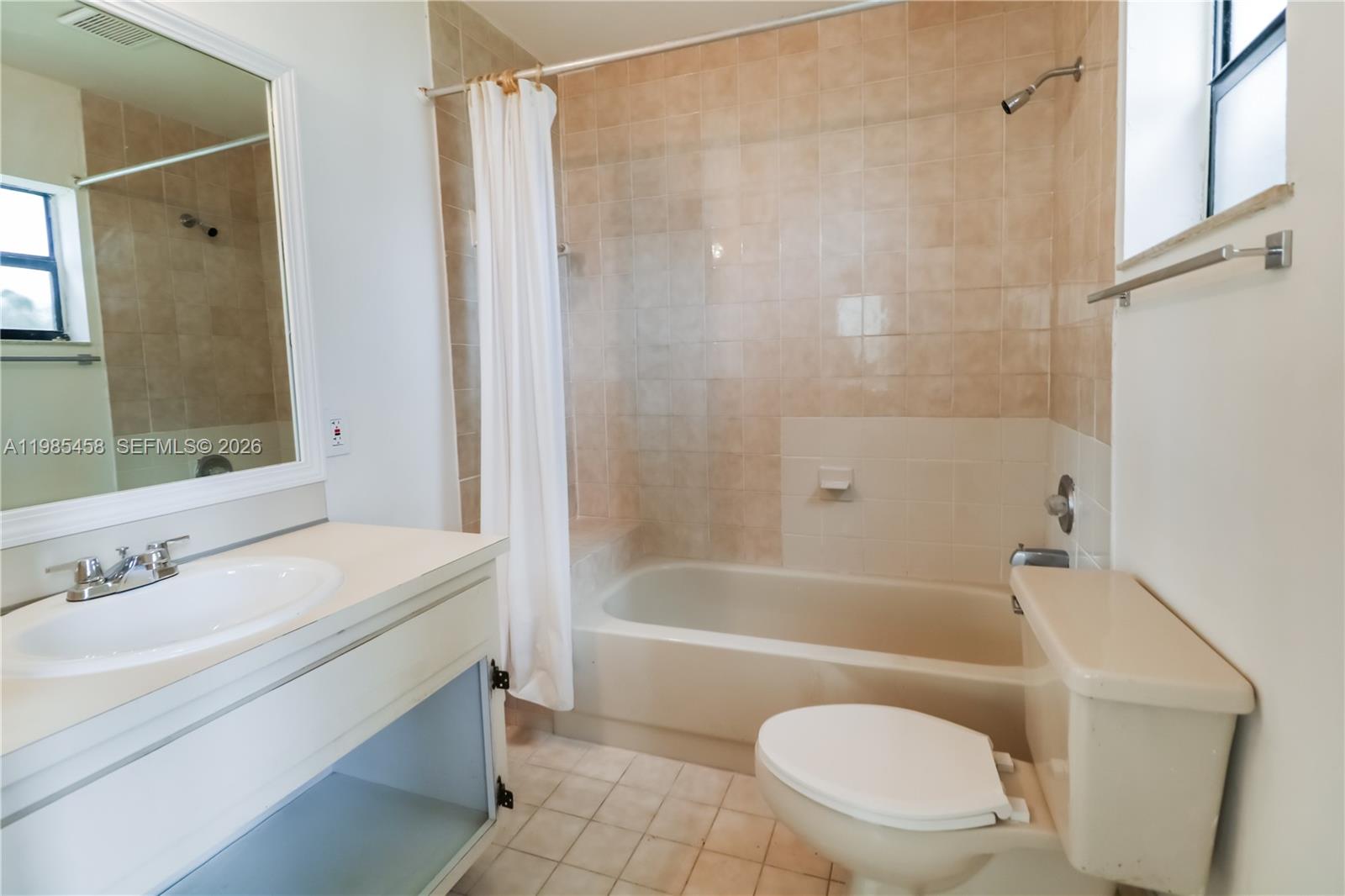 12955 Southwest 66th Lane, Unit 2122 Miami, FL 33183 - Photo 15 of 16 a bathroom with a sink a toilet and a bathtub
