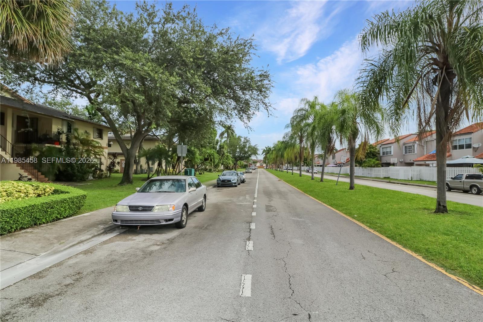 12955 Southwest 66th Lane, Unit 2122 Miami, FL 33183 - Photo 16 of 16 a car parked on the side of the road and yard