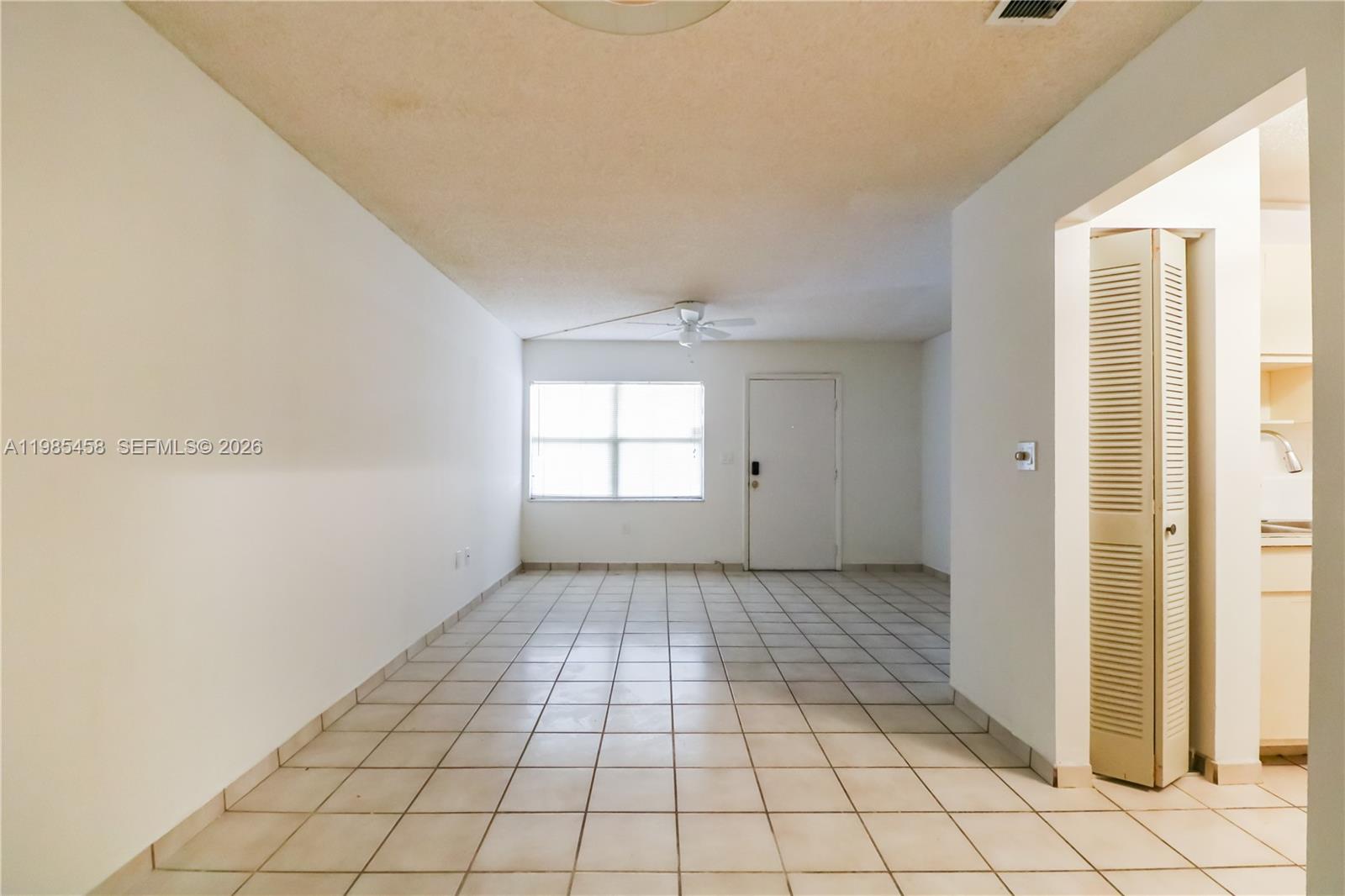 12955 Southwest 66th Lane, Unit 2122 Miami, FL 33183 - Photo 5 of 16 a view of an empty room and window
