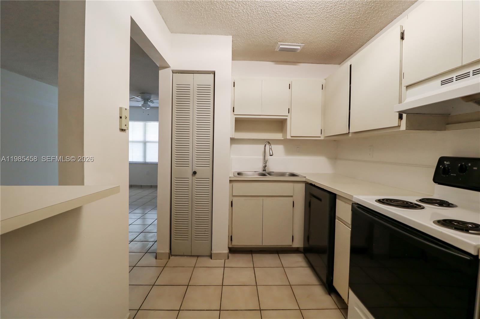 12955 Southwest 66th Lane, Unit 2122 Miami, FL 33183 - Photo 8 of 16 a kitchen with a sink cabinets and appliances