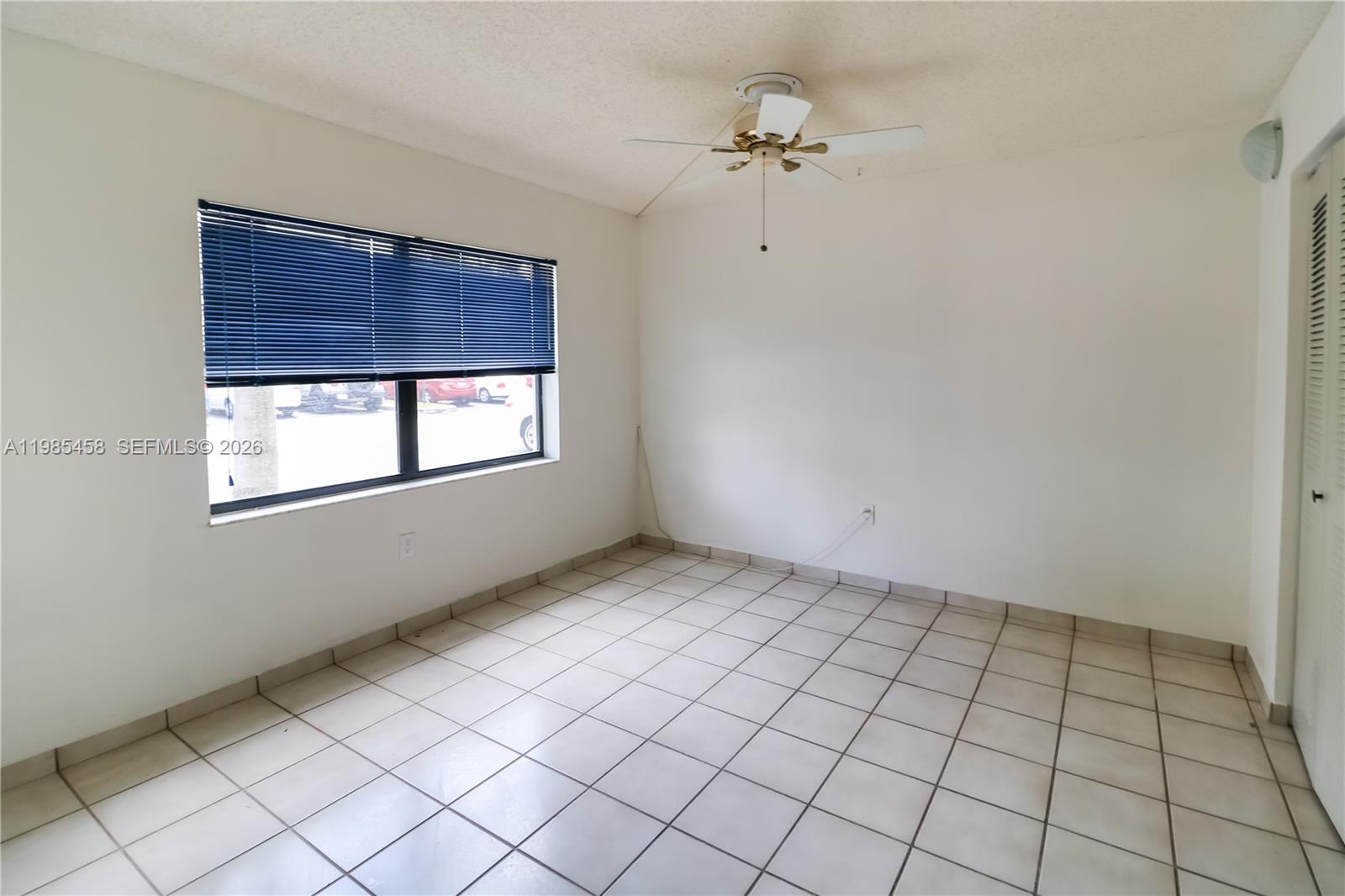 12955 Southwest 66th Lane, Unit 2122 Miami, FL 33183 - Photo 9 of 16 a view of an empty room and window