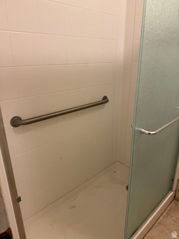 210 South State Street Moroni, UT 84646 - Photo 14 of 23 White tiled shower with a clear glass enclosure and a horizontal grab bar