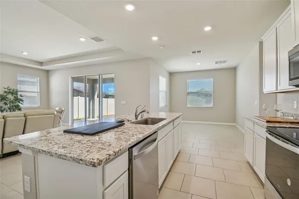 a kitchen with appliances cabinets and furniture