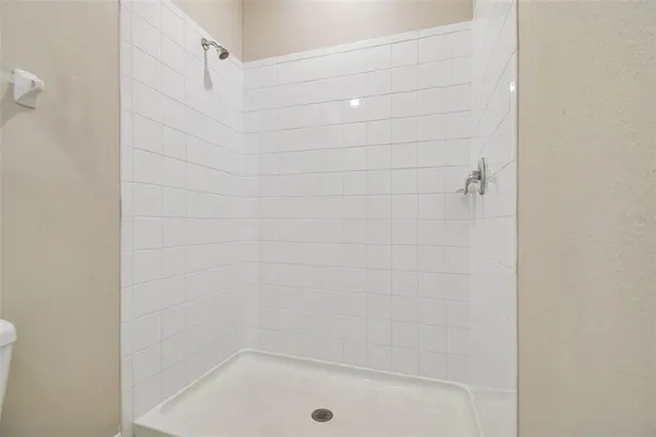 a bathroom with a granite countertop toilet a sink and a mirror