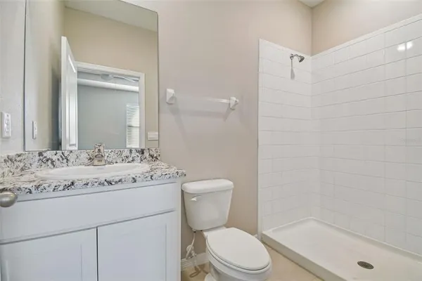 an empty room with fan and entrance