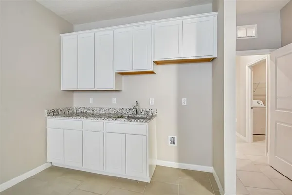 a view of kitchen with a sink cabinets and window
