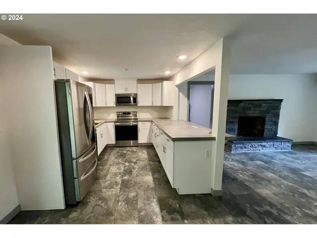 a kitchen with sink refrigerator and microwave