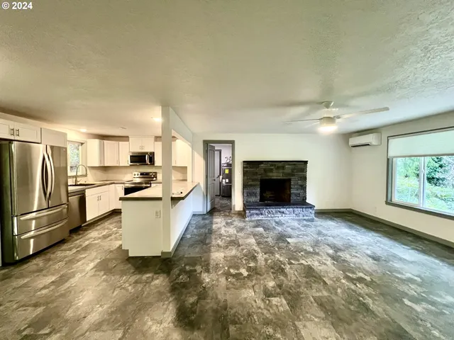 a large open kitchen with a refrigerator a stove top oven a sink and dishwasher