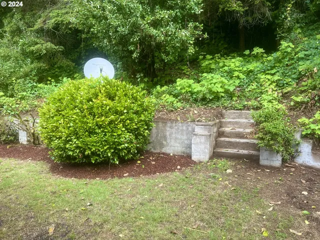 a backyard of a house with a yard and outdoor seating