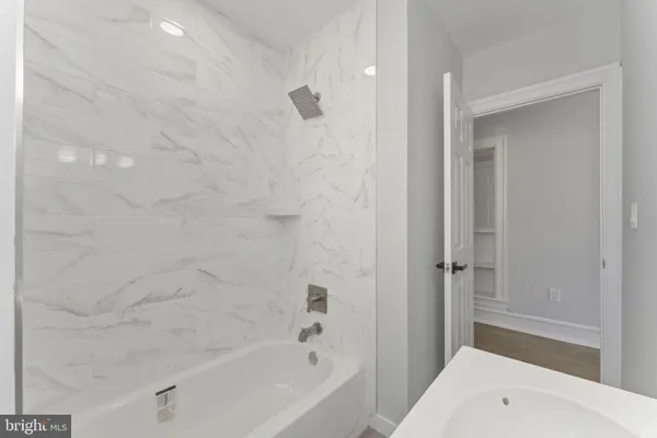 a bathroom with a bathtub and shower