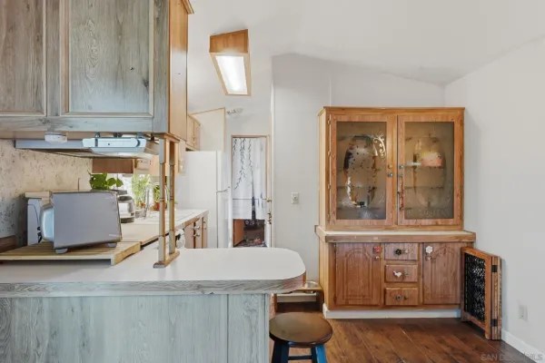 a kitchen with appliances a sink and cabinets
