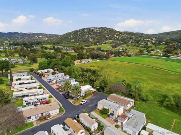 an aerial view of residential houses with outdoor space