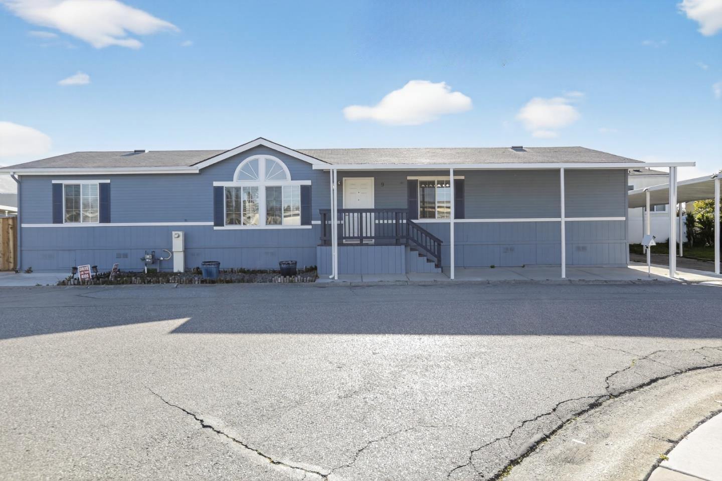 a front view of a house with parking space
