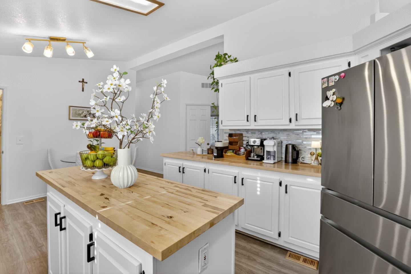 120 Dixon Landing Road, Unit 9 Milpitas, CA 95035 - Photo 19 of 34 a kitchen with stainless steel appliances granite countertop a refrigerator a sink dishwasher and white cabinets with wooden floor