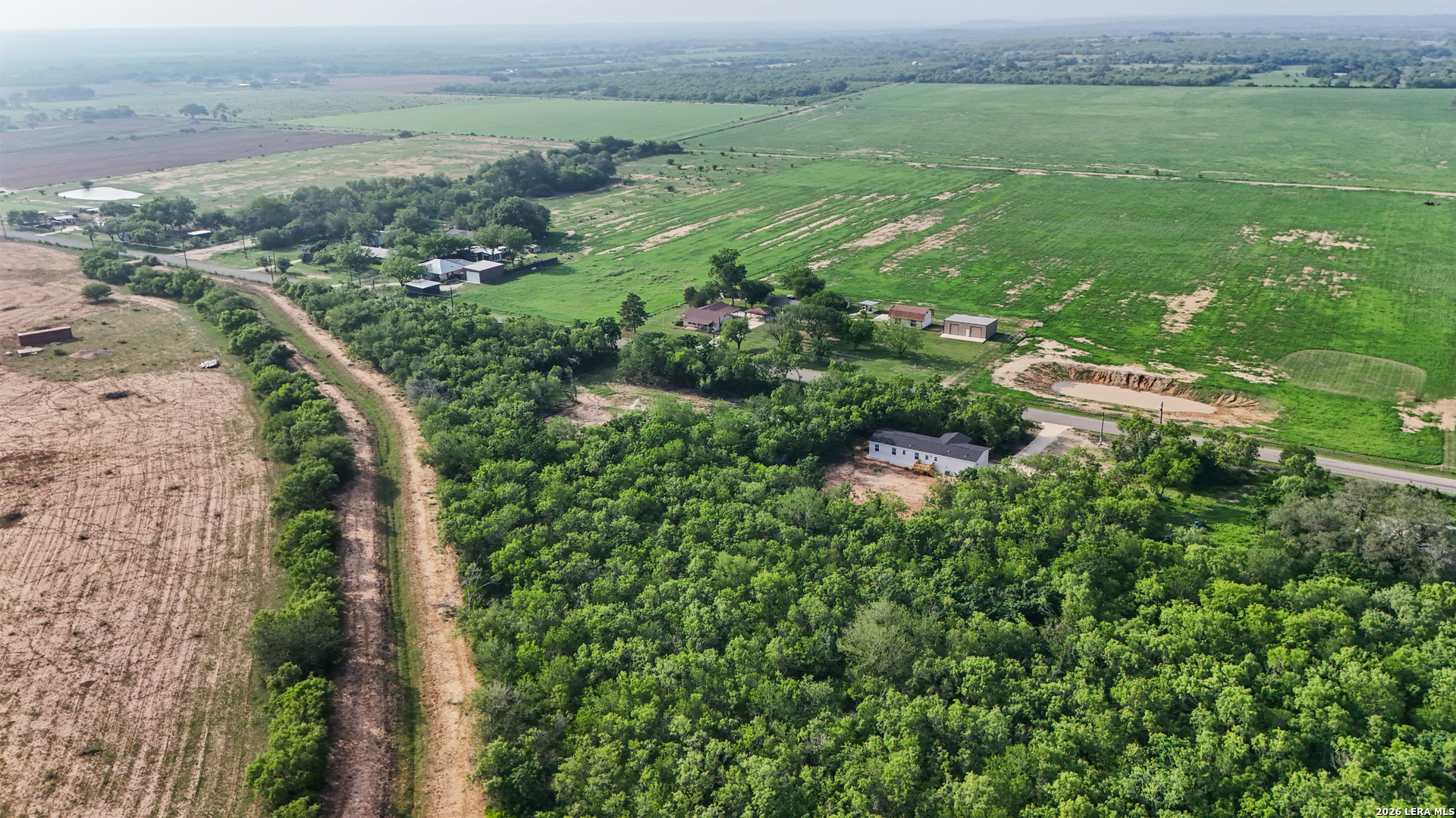 697 County Road 664 Devine, TX 78016 - Photo 3 of 19 an aerial view of residential houses with outdoor space and trees