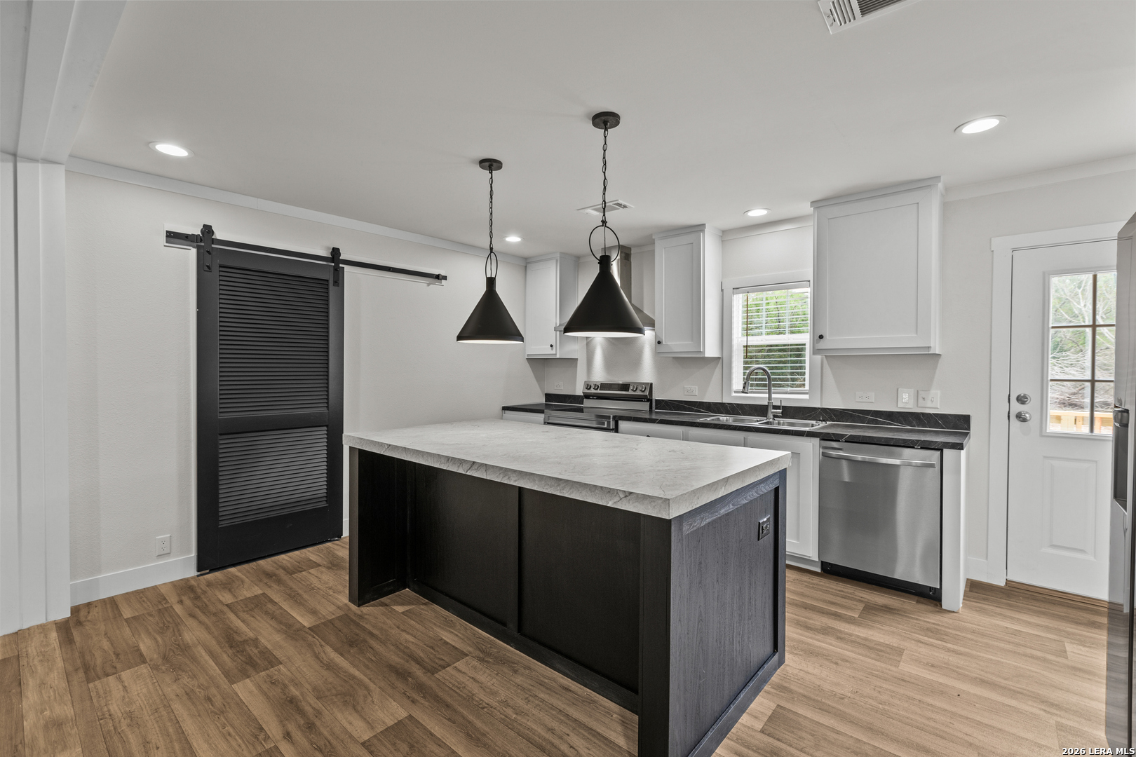 697 County Road 664 Devine, TX 78016 - Photo 5 of 19 a kitchen with stainless steel appliances granite countertop a sink stove and refrigerator