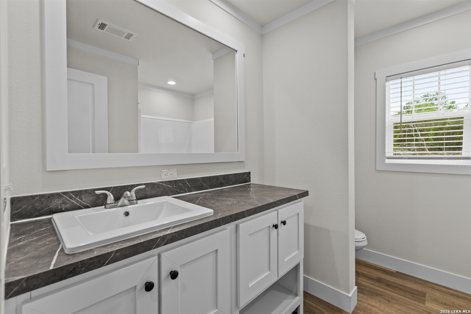 697 County Road 664 Devine, TX 78016 - Photo 9 of 19 a bathroom with a sink a vanity and a mirror