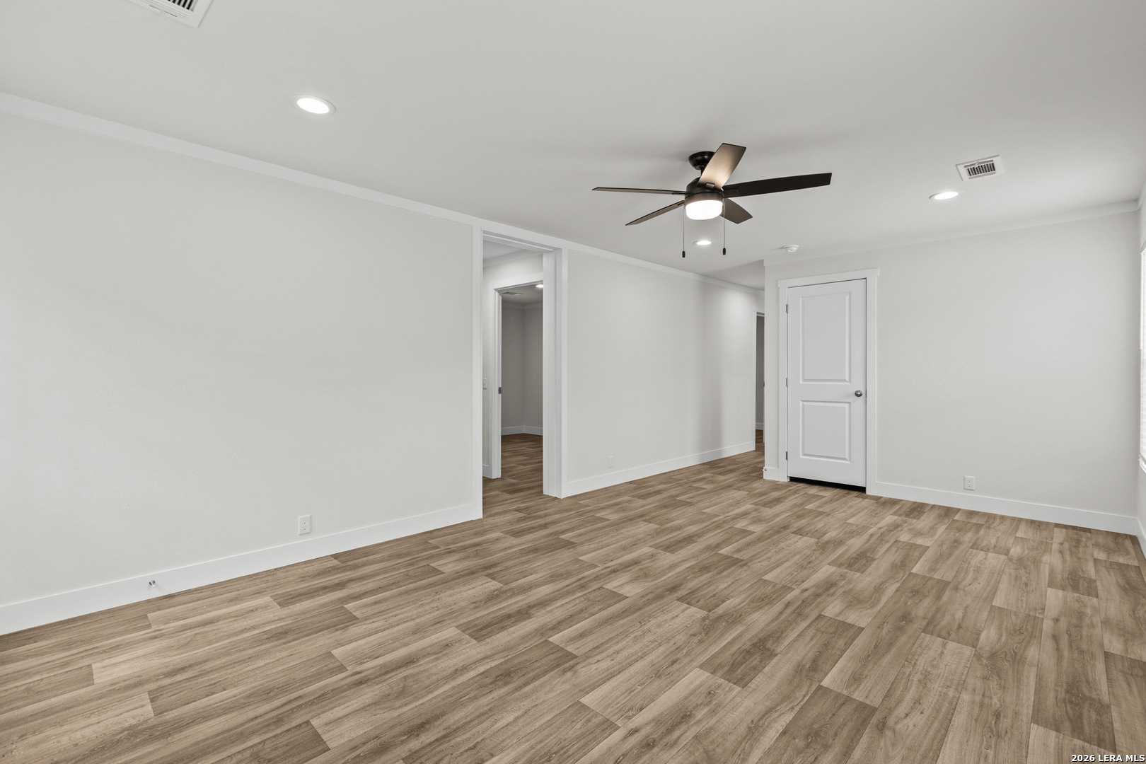 697 County Road 664 Devine, TX 78016 - Photo 10 of 19 wooden floor in an empty room with a window