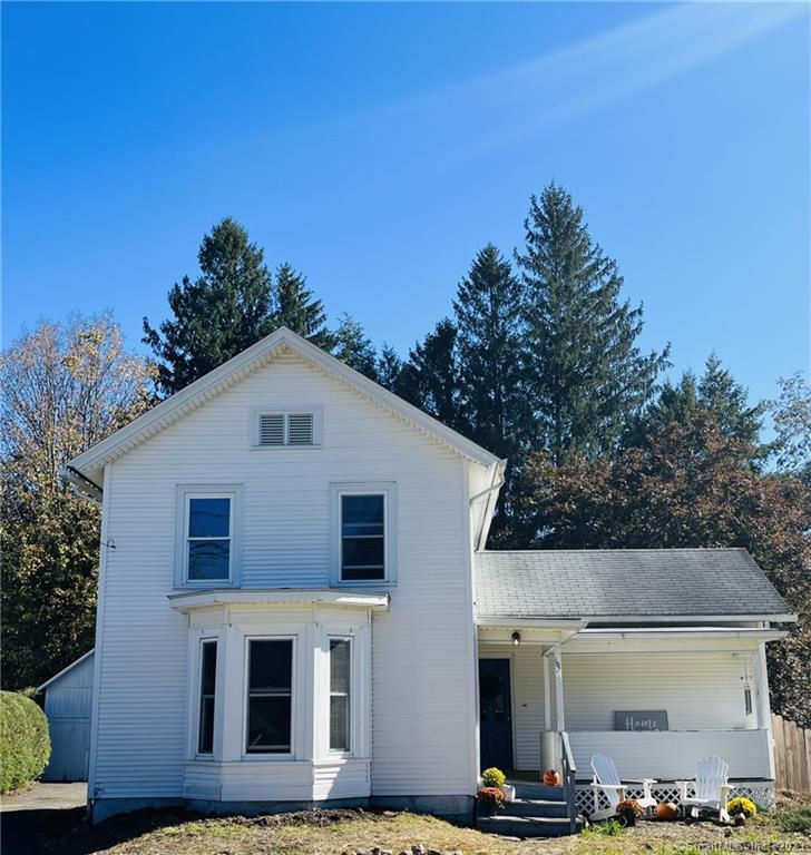 106 New Road Avon, CT 06001 - Photo 1 of 1 a view of a white house with large windows and a small yard