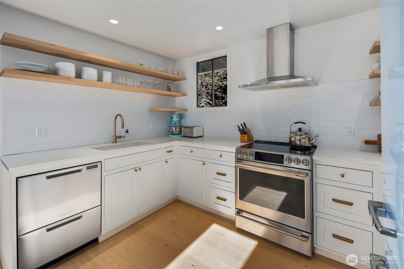 28605 Manzanita Beach Road Southwest Vashon, WA 98070 - Photo 13 of 39 a kitchen with white cabinets stainless steel appliances and sink