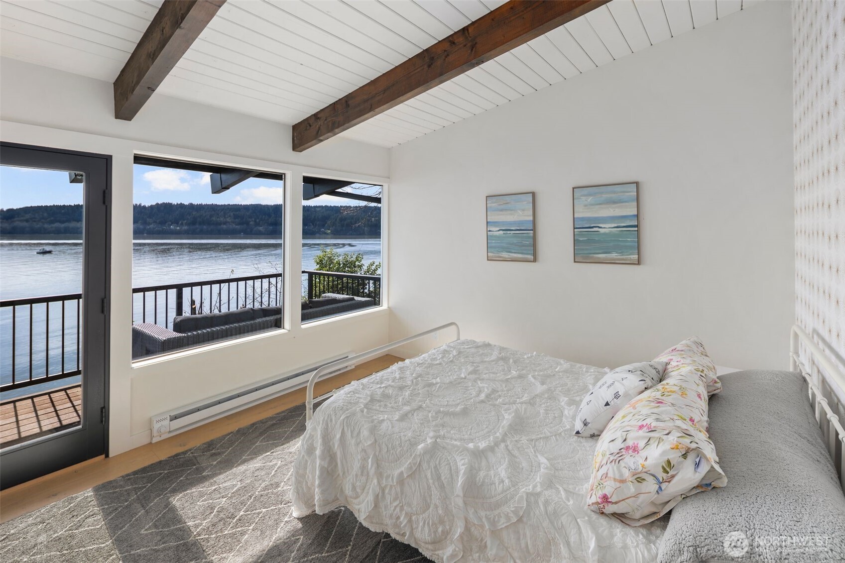 28605 Manzanita Beach Road Southwest Vashon, WA 98070 - Photo 16 of 39 a bedroom with a bed and a large window with balcony view