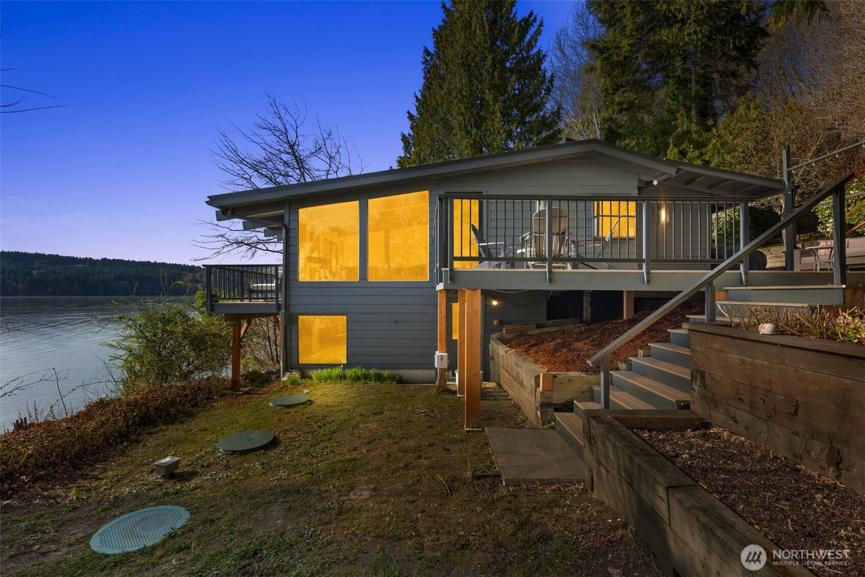 28605 Manzanita Beach Road Southwest Vashon, WA 98070 - Photo 2 of 39 a view of a house with backyard and porch