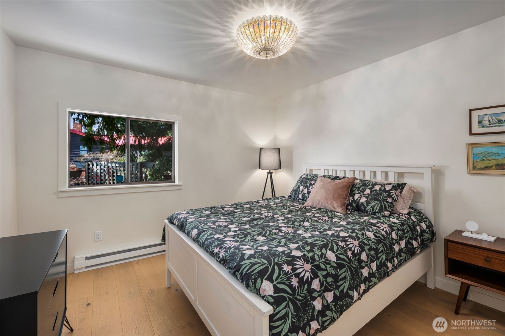 28605 Manzanita Beach Road Southwest Vashon, WA 98070 - Photo 23 of 39 a bedroom with a bed and a chandelier
