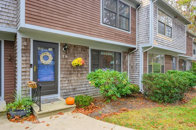 a front view of a house with outdoor seating