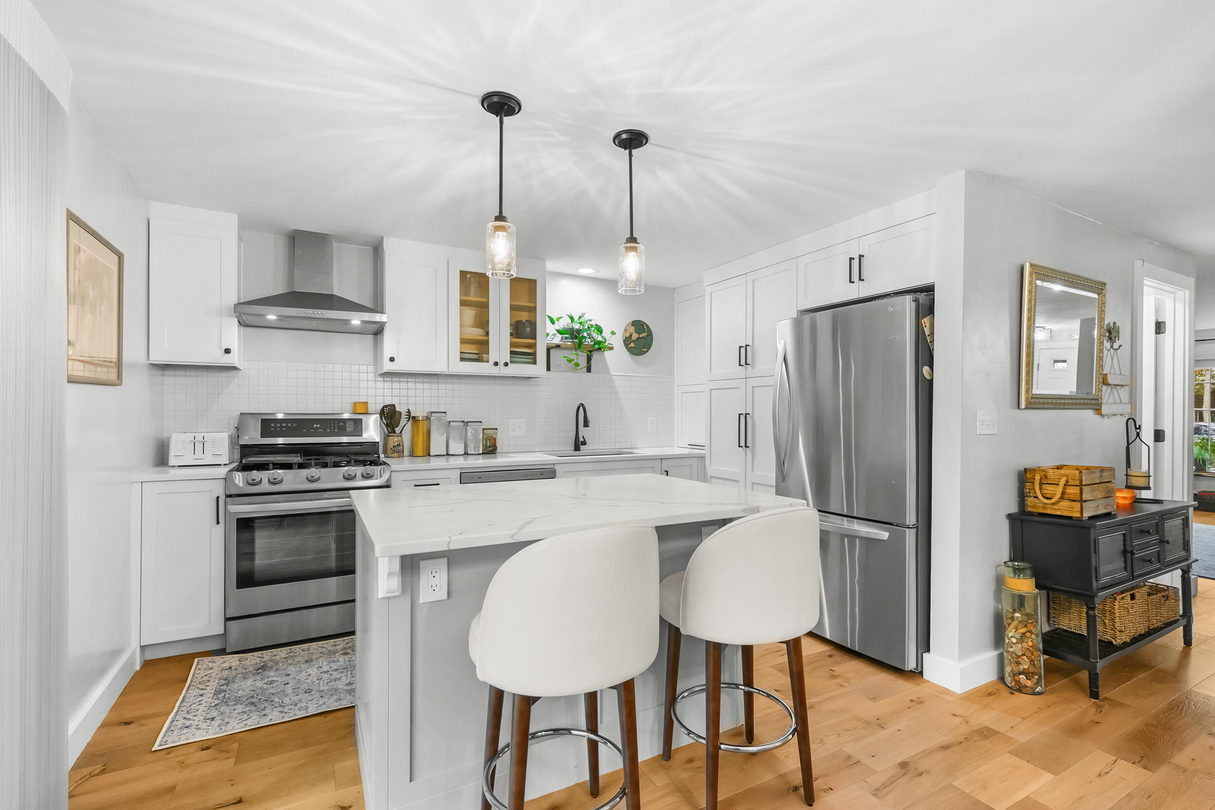 195 Falmouth Road, Unit 7B Mashpee, MA 02649 - Photo 13 of 38 a kitchen with stainless steel appliances granite countertop a stove refrigerator and chairs