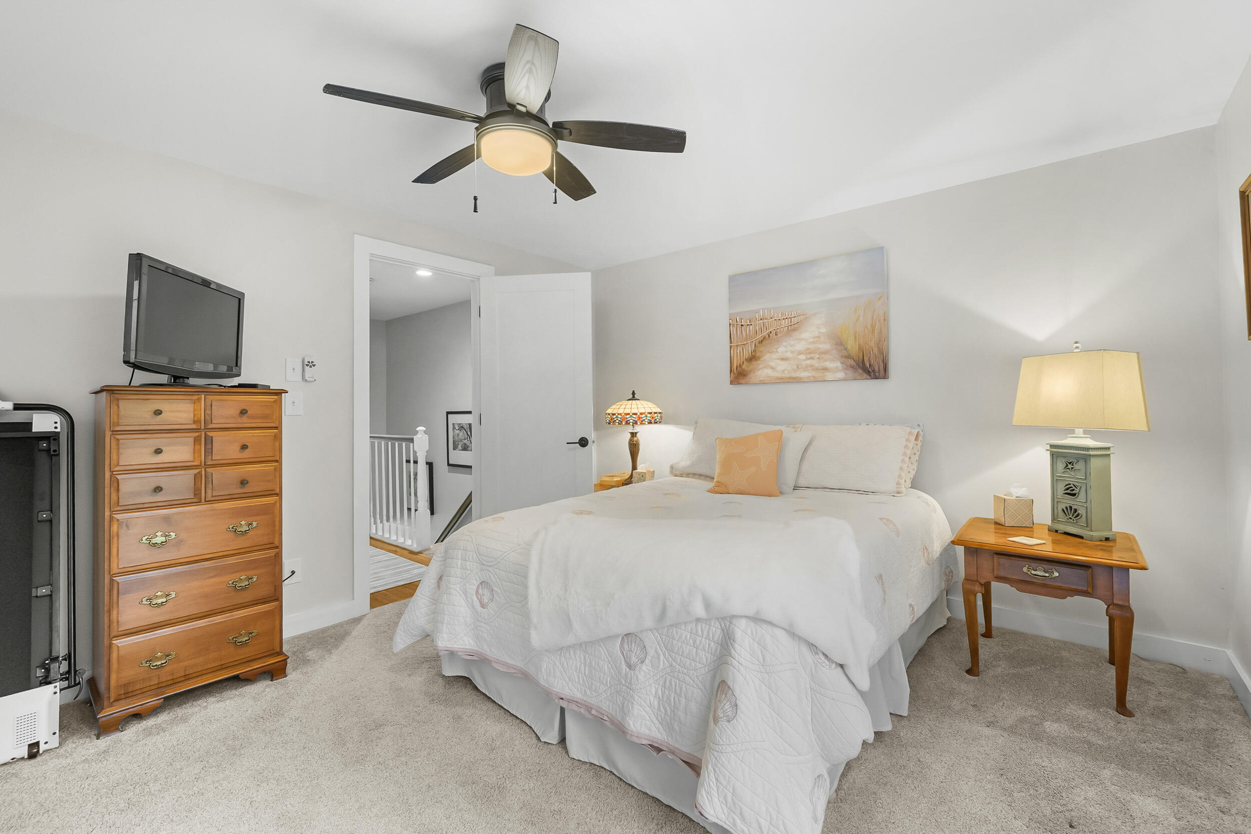 195 Falmouth Road, Unit 7B Mashpee, MA 02649 - Photo 21 of 38 a bedroom with a bed and a lamp on a dresser