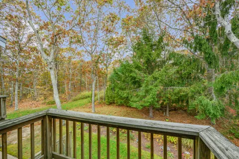 a view of a balcony with trees