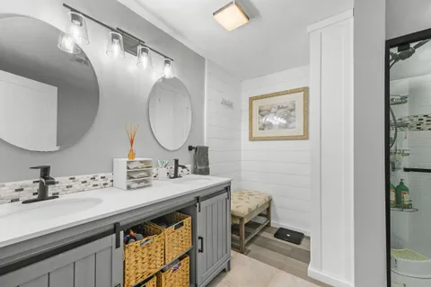 a bathroom with a double vanity sink mirror and toilet