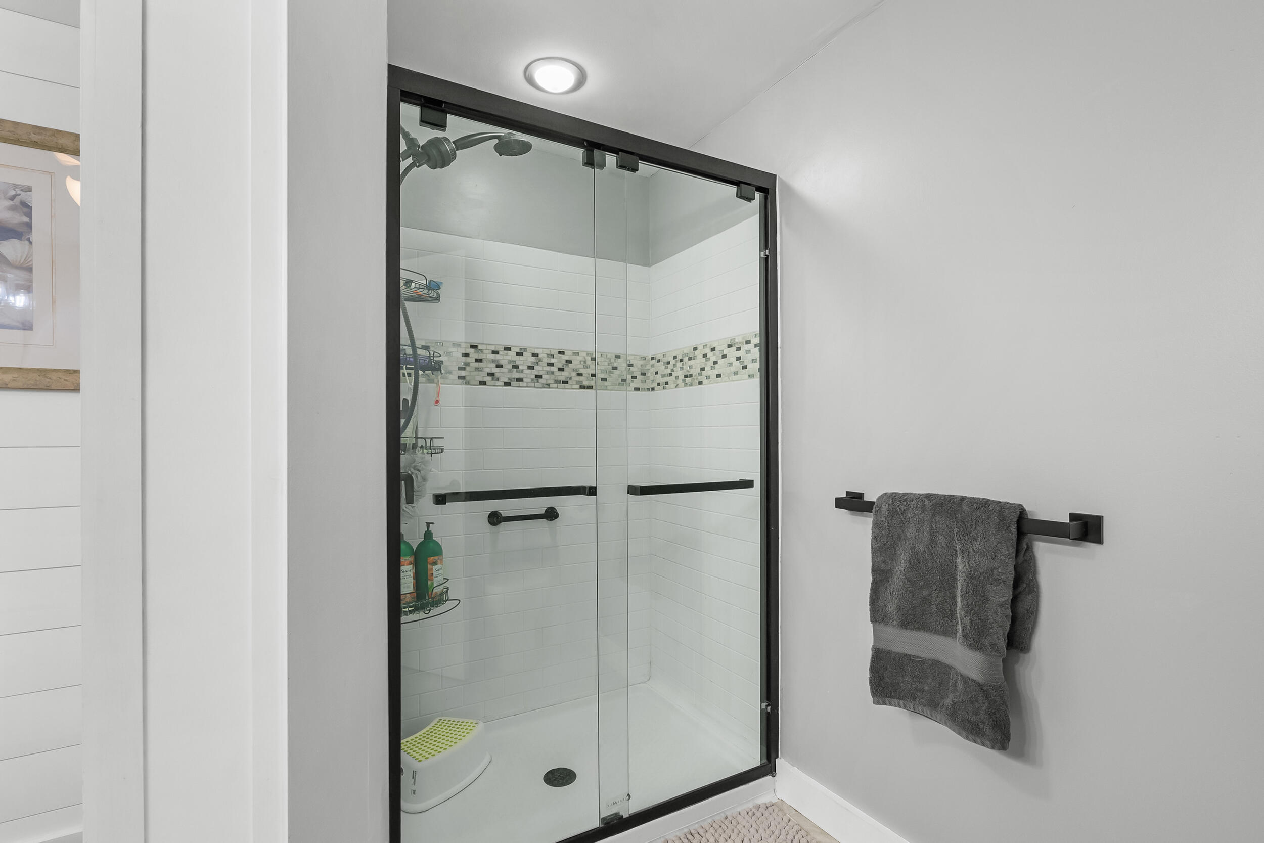 195 Falmouth Road, Unit 7B Mashpee, MA 02649 - Photo 28 of 38 a bathroom with a glass shower door and a mirror