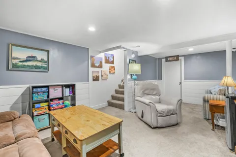 a living room with furniture and a bookshelf