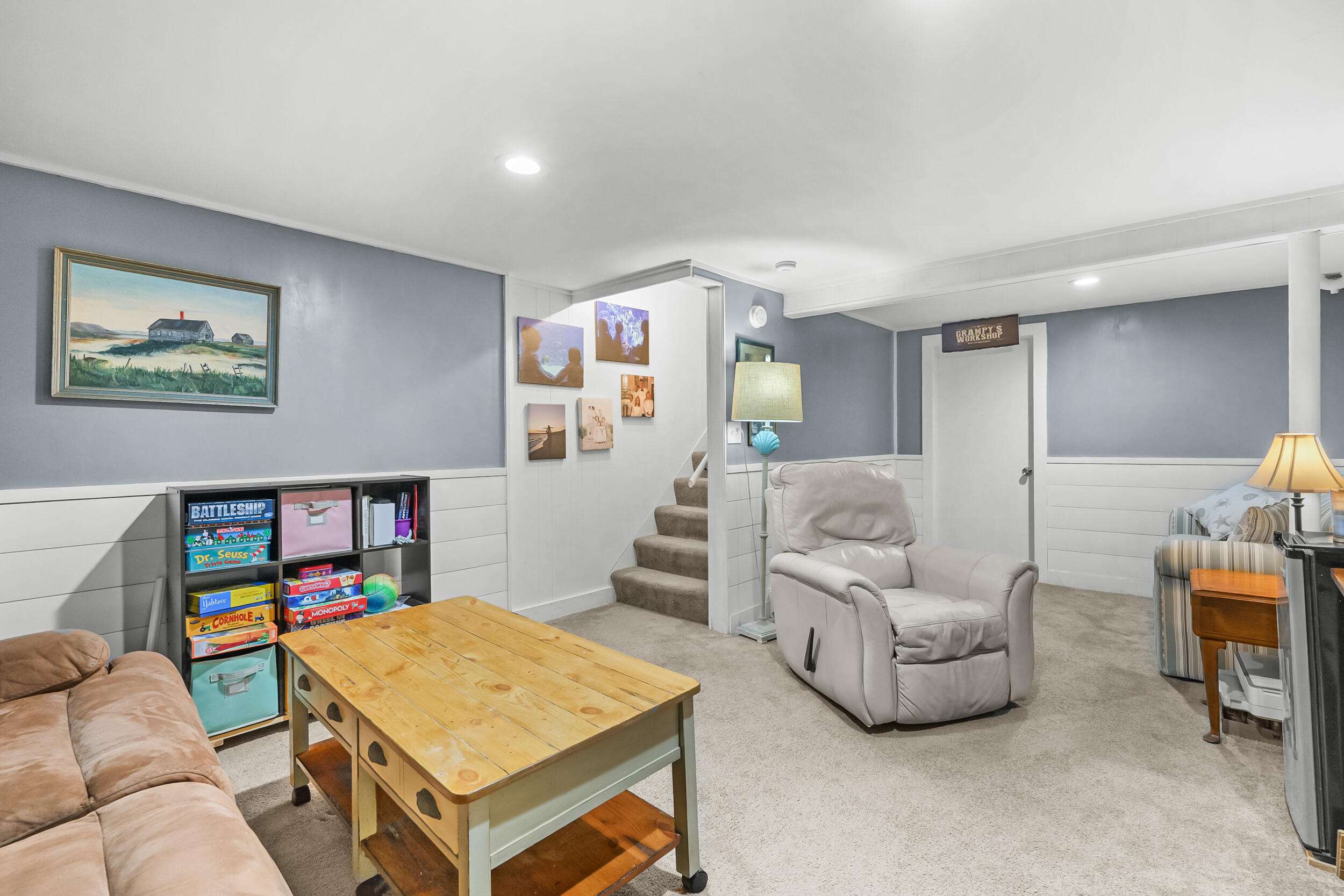 195 Falmouth Road, Unit 7B Mashpee, MA 02649 - Photo 29 of 38 a living room with furniture and a bookshelf