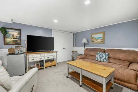 a bedroom with furniture and a flat screen tv