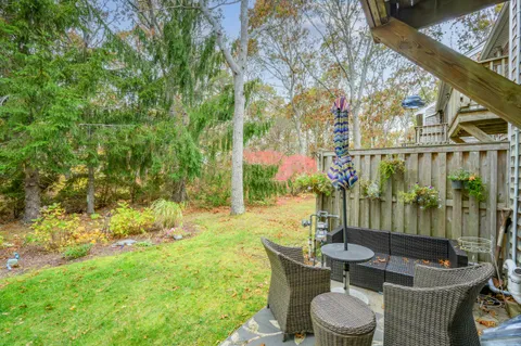 a view of a patio with couches table and chairs and potted plants