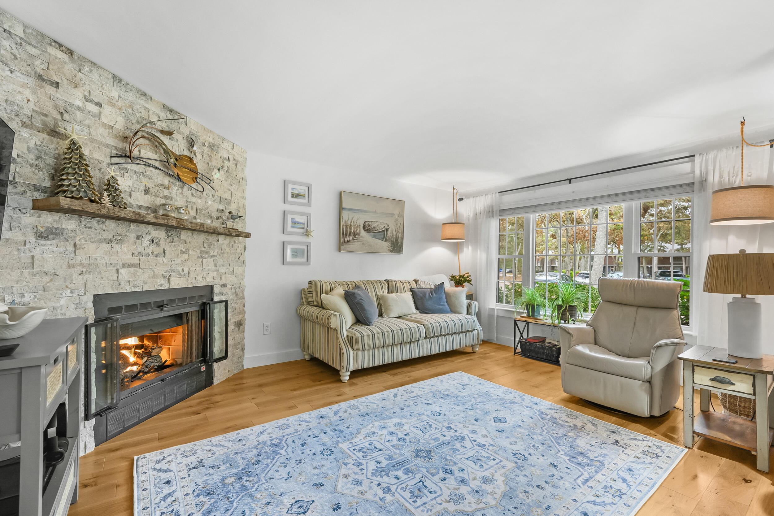 195 Falmouth Road, Unit 7B Mashpee, MA 02649 - Photo 4 of 38 a living room with furniture and a fireplace
